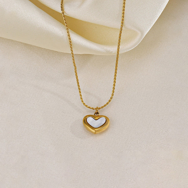 Adore You necklace by Everray on a beige fabric background
