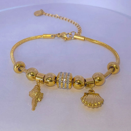 Bold coral Charm Summer Bracelet by everray with various charms on a white background