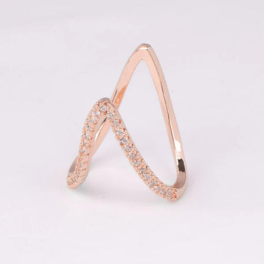 Rose gold ring with small diamonds on a light gray background