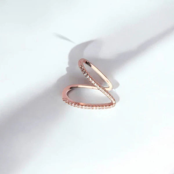 Rose gold ring with small diamonds on a white background