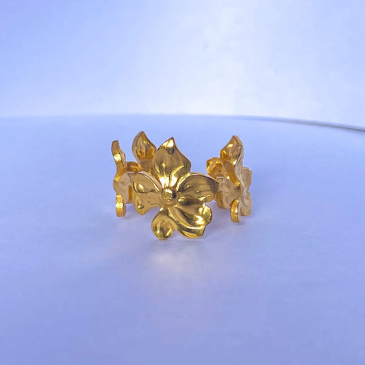 Gold Flower Statement ring by everray on a light blue background