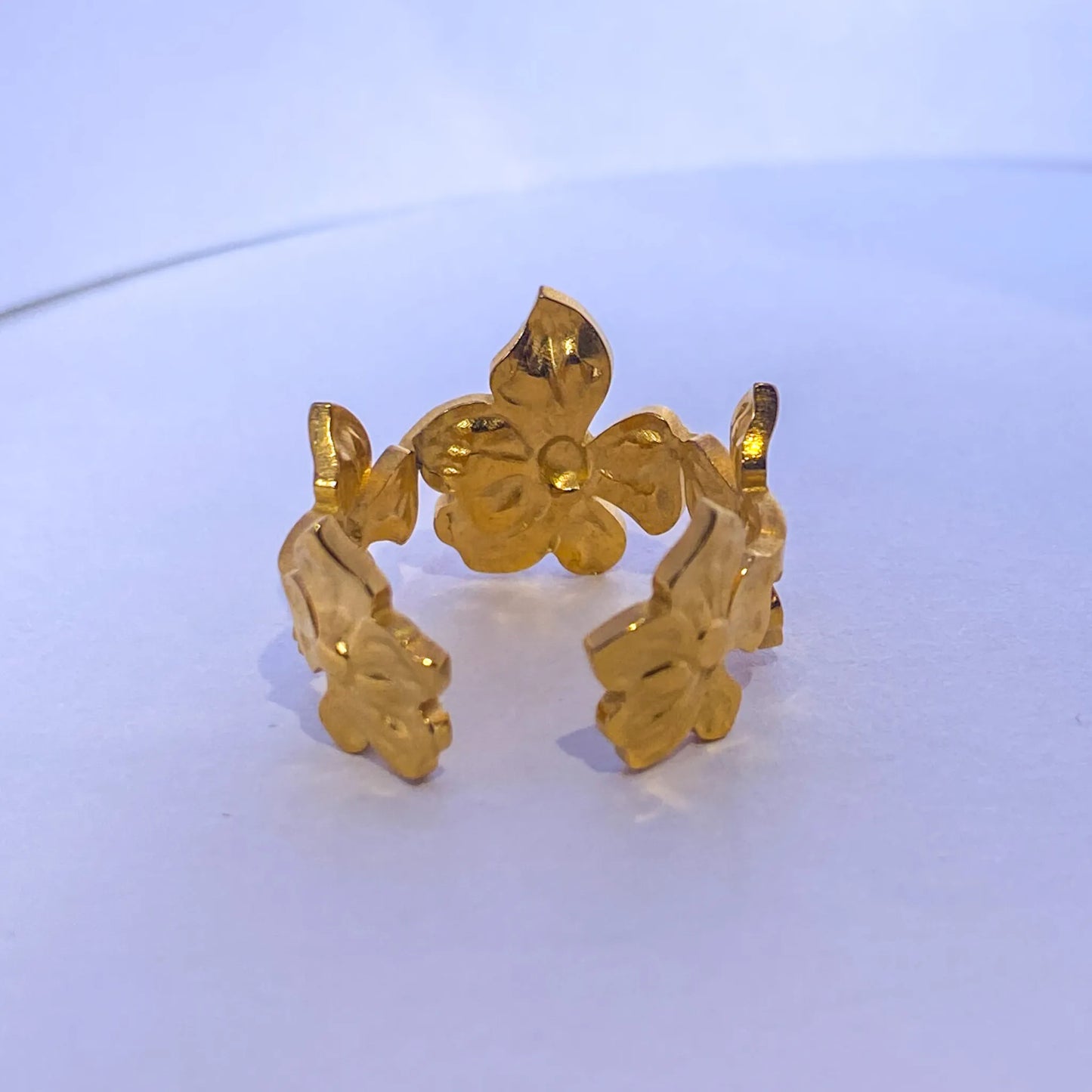 Gold Flower Statement ring by everrayon a light blue background
