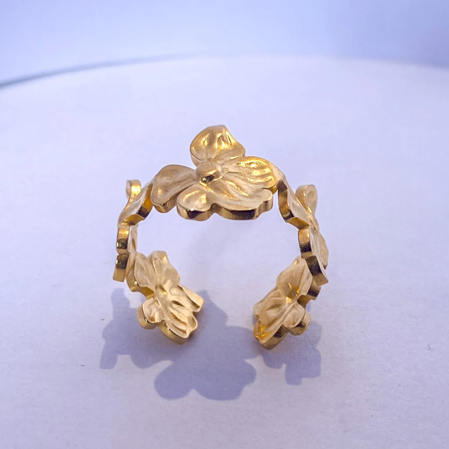 Gold Flower Statement ring by everray on a light purple background