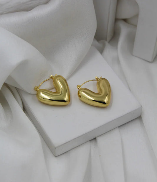 Heart_hoops_01_by_EVerray-shaped hoop earrings on a white stone surface