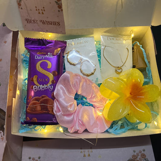 Rakhi Gift box withJewellery, Scrunchie , claw , Cadbury chocolate, and a card inside.