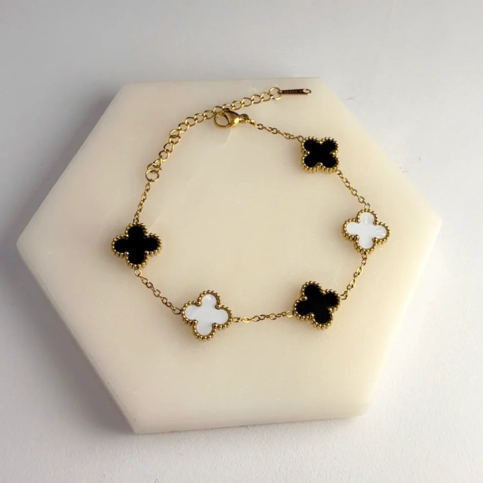 3 in 1 Reversible Clover Bracelet B/W by everray on a beige stand.
