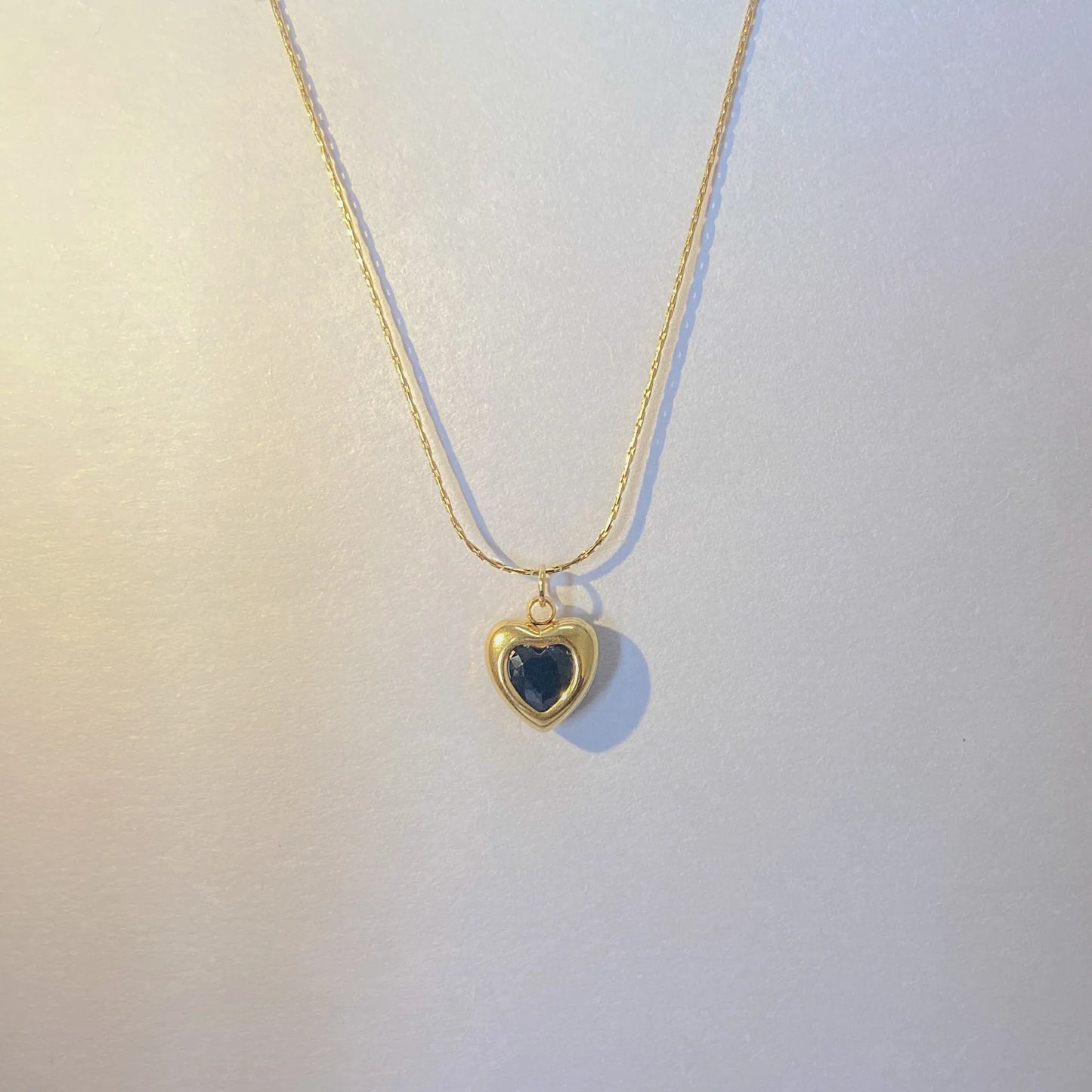  Adore You Black Necklace with a heart-shaped pendant on a light background