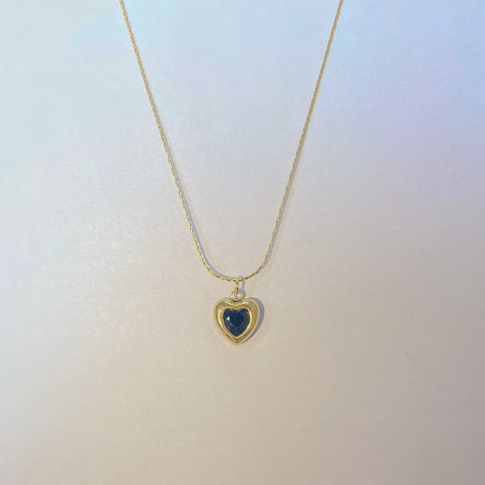 Adore you black necklace with a heart-shaped pendant on a light gradient background