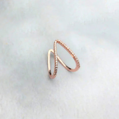 Rose gold ring with a subtle design on a light gray background