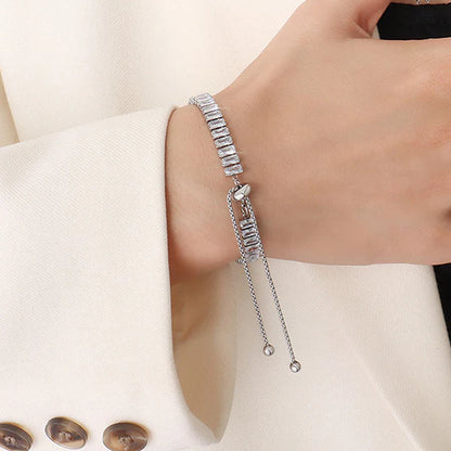 Silver bracelet with clear stones on a person's wrist against a white background