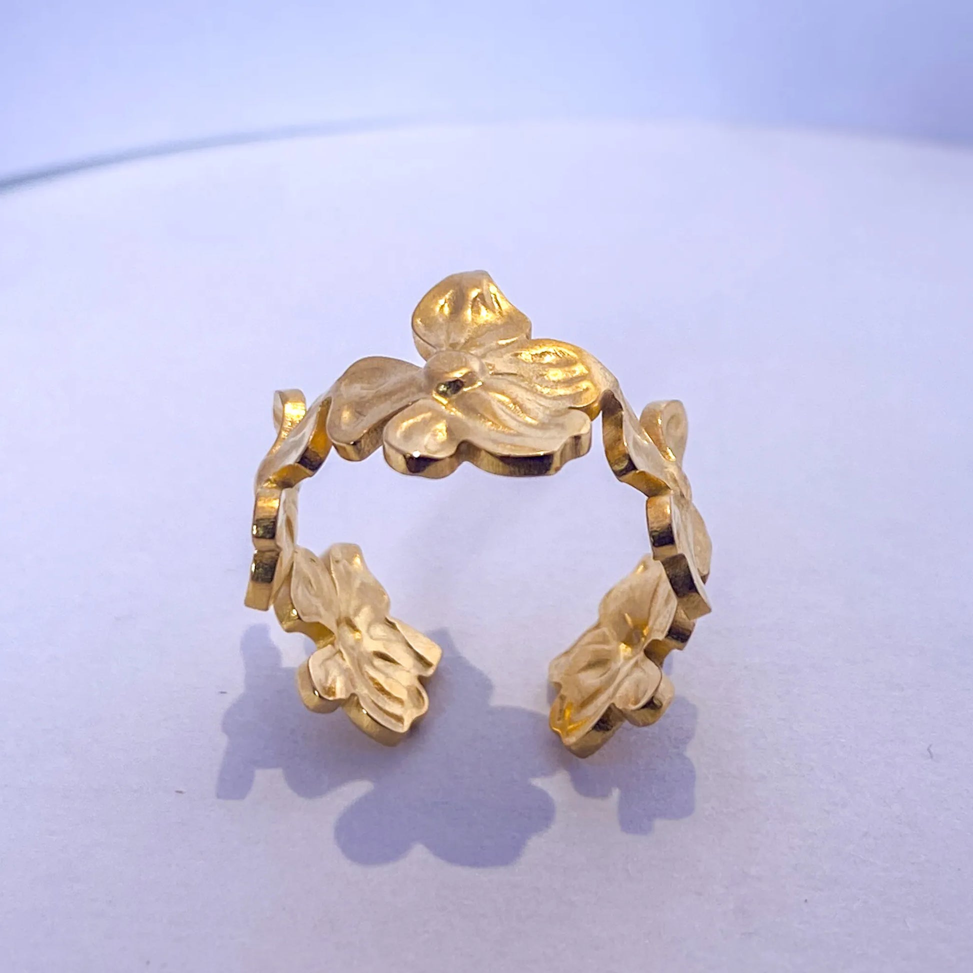 Gold Flower Statement ring by everray on a light purple background