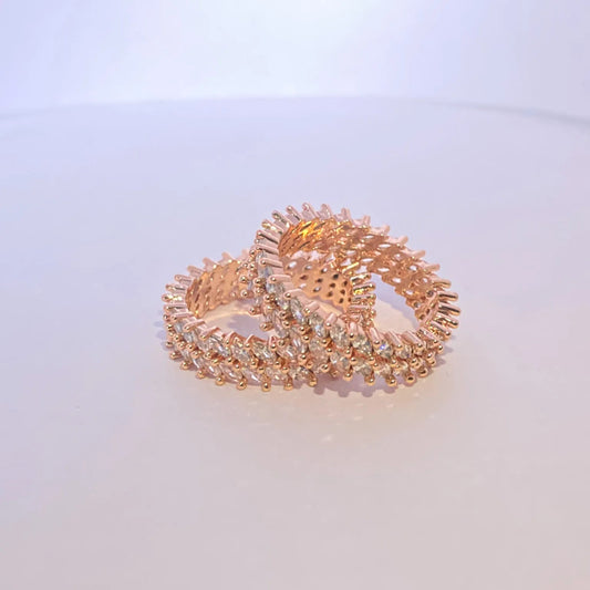 Rose gold rings on a light purple background