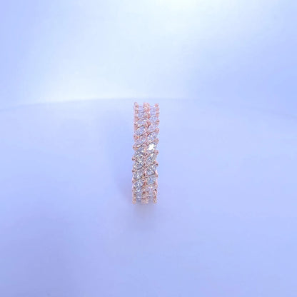 Rose gold earring with clear stones on a light blue background