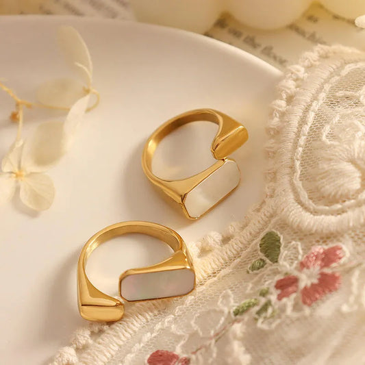 Gold mother of pearl ring on a floral fabric background