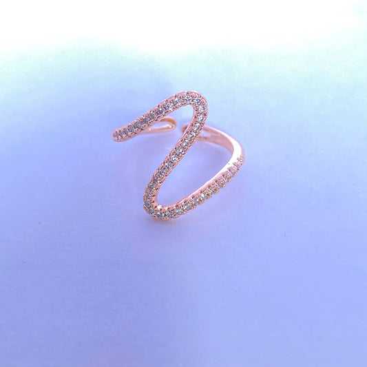 Rose gold ring with gemstones on a gradient blue background