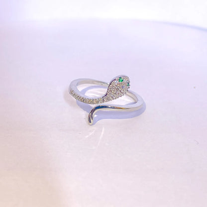 Silver ring with green gemstone on a light gradient background