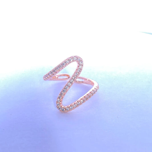 Rose gold ring with gemstones on a gradient background